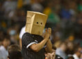 OAKLAND, CALIFORNIA - AUGUST 06: A spectator wearing a paper bag on their head claps after the Chicago White Sox record an out in the bottom of the eighth inning against the Oakland Athletics at Oakland Coliseum on August 06, 2024 in Oakland, California. (Photo by Lachlan Cunningham/Getty Images)