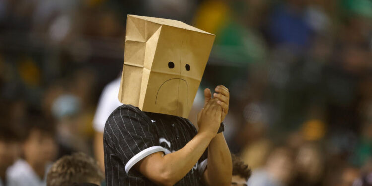 OAKLAND, CALIFORNIA - AUGUST 06: A spectator wearing a paper bag on their head claps after the Chicago White Sox record an out in the bottom of the eighth inning against the Oakland Athletics at Oakland Coliseum on August 06, 2024 in Oakland, California. (Photo by Lachlan Cunningham/Getty Images)