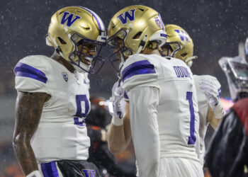 CORVALLIS, OREGON - NOVEMBER 18: Wide receiver Rome Odunze #1 of the Washington Huskies celebrates his touchdown catch with Michael Penix Jr. #9 of the Washington Huskies during the first half against the Oregon State Beavers  at Reser Stadium on November 18, 2023 in Corvallis, Oregon. (Photo by Tom Hauck/Getty Images)