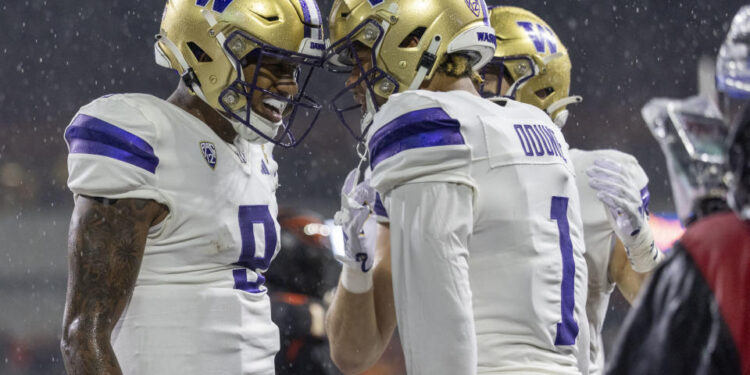 CORVALLIS, OREGON - NOVEMBER 18: Wide receiver Rome Odunze #1 of the Washington Huskies celebrates his touchdown catch with Michael Penix Jr. #9 of the Washington Huskies during the first half against the Oregon State Beavers  at Reser Stadium on November 18, 2023 in Corvallis, Oregon. (Photo by Tom Hauck/Getty Images)