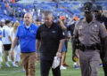 Florida head coach Billy Napier, center, walks off the field after his team was defeated by Miami, 41-17, in an NCAA college football game, Saturday, Aug. 31, 2024, in Gainesville, Fla. (AP Photo/John Raoux)