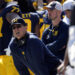 FILE - Michigan head coach Jim Harbaugh, front left, watches against Rutgers as analytics assistant Connor Stalions, right, looks on during an NCAA college football game in Ann Arbor, Mich., Sept. 23, 2023. A Michigan judge who champions peacemaking principles in court will preside over a hearing on Friday that will determine whether Jim Harbaugh can coach and close the regular season on the field with the third-ranked Wolverines. Attorneys for Harbaugh and the university are asking Judge Timothy P. Connors to at least temporarily lift the Big Ten’s penalty against him for a sign-stealing scheme. (AP Photo/Paul Sancya, FILE)