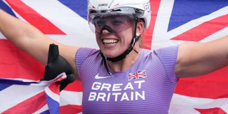 Hannah Cockroft celebrating with the Union flag after winning a gold at the Para Athletics World Championships