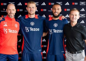 Matthijs de Ligt and Noussair Mazraoui of Manchester United pose with manager Erik ten Hag and Sporting Director Dan Ashworth after signing for the club, August 13, 2024