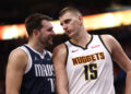 Luka Doncic #77 of the Dallas Mavericks and Nikola Jokic #15 of the Denver Nuggets