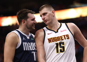 Luka Doncic #77 of the Dallas Mavericks and Nikola Jokic #15 of the Denver Nuggets