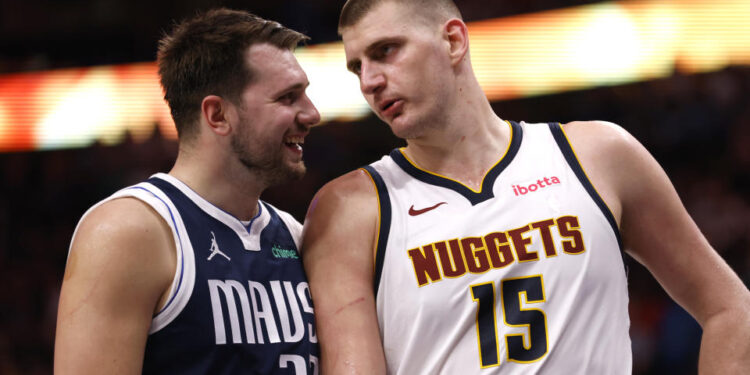 Luka Doncic #77 of the Dallas Mavericks and Nikola Jokic #15 of the Denver Nuggets