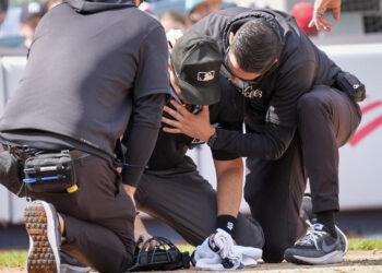 Nick Mahrley was carried off the field on a stretcher after being hit in the head with the barrel of Giancarlo Stanton's bat. (AP Photo/Bryan Woolston)