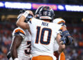 DENVER, COLORADO - AUGUST 18: Bo Nix #10 of the Denver Broncos celebrates with teammates in the first half of the preseason game against the Green Bay Packers at Empower Field At Mile High on August 18, 2024 in Denver, Colorado. (Photo by Tyler Schank/Getty Images)