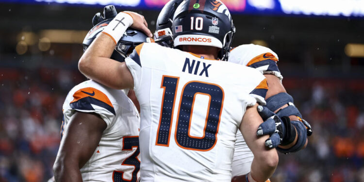 DENVER, COLORADO - AUGUST 18: Bo Nix #10 of the Denver Broncos celebrates with teammates in the first half of the preseason game against the Green Bay Packers at Empower Field At Mile High on August 18, 2024 in Denver, Colorado. (Photo by Tyler Schank/Getty Images)