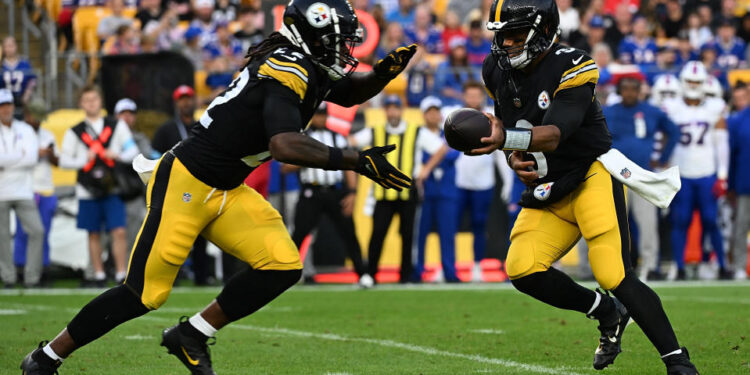 PITTSBURGH, PENNSYLVANIA - AUGUST 17: Russell Wilson #3 of the Pittsburgh Steelers hands the ball off to Najee Harris #22 in the first quarter during the preseason game against the Buffalo Bills at Acrisure Stadium on August 17, 2024 in Pittsburgh, Pennsylvania. (Photo by Justin Berl/Getty Images)