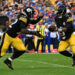 PITTSBURGH, PENNSYLVANIA - AUGUST 17: Russell Wilson #3 of the Pittsburgh Steelers hands the ball off to Najee Harris #22 in the first quarter during the preseason game against the Buffalo Bills at Acrisure Stadium on August 17, 2024 in Pittsburgh, Pennsylvania. (Photo by Justin Berl/Getty Images)