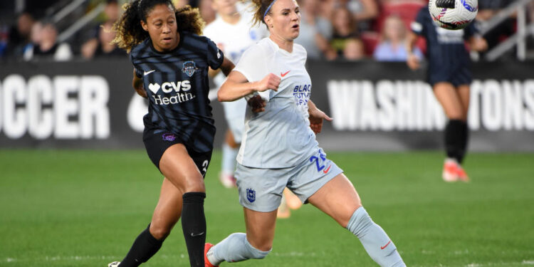 WASHINGTON, DC - MAY 24: Washington Spirit midfielder Casey Krueger (3) battles Seattle Reign midfielder Veronica Latsko for a loose ball during NWSL soccer match between the Seattle Reign and the Washington Spirit on May 24, 2024, at Audi Field in Washington, DC. (Photo by John Rivera/Icon Sportswire via Getty Images)