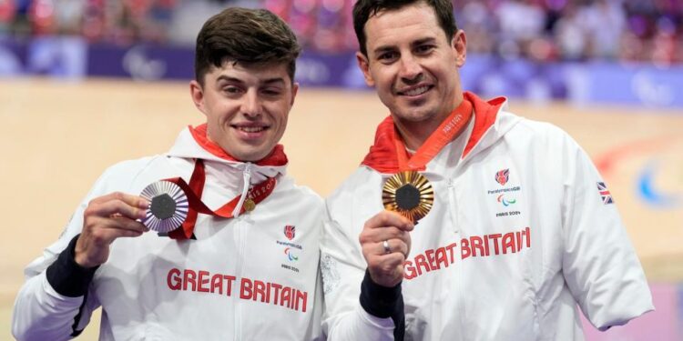 Jaco van Gass (right) and Finlay Graham – 'Mr Indestructible' Jaco Van Gass retains cycling gold a week after colliding with a car