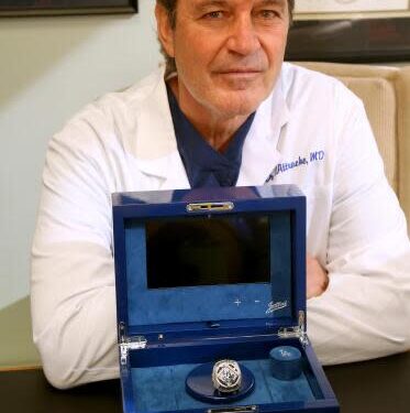 Dr. Neal ElAttrache sits with the 2020 World Series ring presented to him by the Dodgers in his office on Dec. 13, 2023.