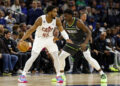 Donovan Mitchell #45 of the Cleveland Cavaliers dribbles the ball while Anthony Edwards #1 of the Minnesota Timberwolves defends