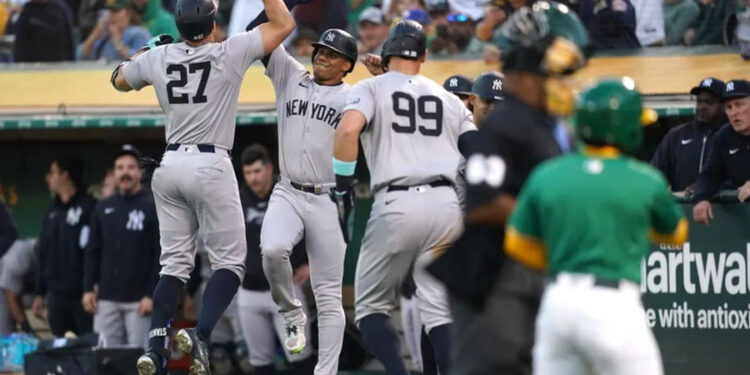 Sep 21, 2024; Oakland, California, USA; New York Yankees designated hitter Giancarlo Stanton (27) is congratulated by right fielder Juan Soto (22) after hitting a three-run home run against the Oakland Athletics in the third inning at the Oakland-Alameda County Coliseum. Mandatory Credit: Cary Edmondson-Imagn Images