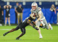 Sep 13, 2024; Kansas City, Kansas, USA; UNLV Rebels quarterback Matthew Sluka (3) runs the ball against Kansas Jayhawks safety O.J. Burroughs (5) during the second half at Children's Mercy Park. Mandatory Credit: Jay Biggerstaff-Imagn Images