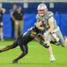 Sep 13, 2024; Kansas City, Kansas, USA; UNLV Rebels quarterback Matthew Sluka (3) runs the ball against Kansas Jayhawks safety O.J. Burroughs (5) during the second half at Children's Mercy Park. Mandatory Credit: Jay Biggerstaff-Imagn Images