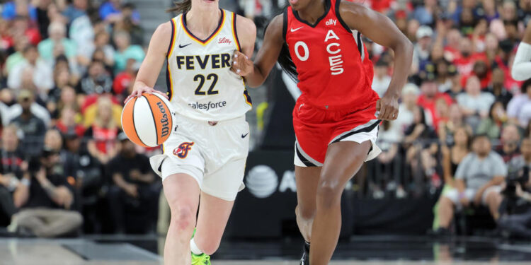 LAS VEGAS, NEVADA - JULY 02: Caitlin Clark #22 of the Indiana Fever brings the ball up the court against Jackie Young #0 of the Las Vegas Aces in the second quarter of their game at T-Mobile Arena on July 02, 2024 in Las Vegas, Nevada. The Aces defeated the Fever 88-69. NOTE TO USER: User expressly acknowledges and agrees that, by downloading and or using this photograph, User is consenting to the terms and conditions of the Getty Images License Agreement. (Photo by Ethan Miller/Getty Images)