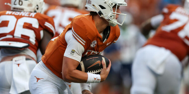 AUSTIN, TX - SEPTEMBER 14: Texas Longhorns quarterback Arch Manning (16) runs the ball for a touchdown during the first half of the game against the UTSA Roadrunners on September 14, 2024, at Darrell K Royal - Texas Memorial Stadium in Austin, TX. (Photo by Adam Davis/Icon Sportswire via Getty Images)