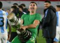 Argentina goalkeeper Emiliano Martinez holds a replica Copa America trophy against his crotch