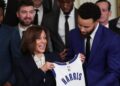 Golden State Warriors star Steph Curry presents U.S. Vice President Kamala Harris with a jersey.