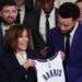 Golden State Warriors star Steph Curry presents U.S. Vice President Kamala Harris with a jersey.