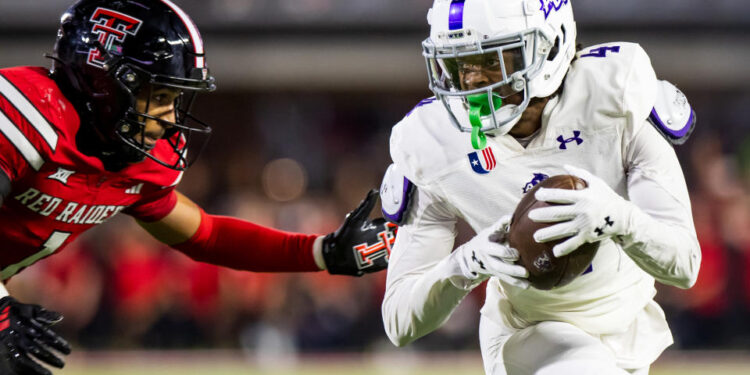 LUBBOCK, TEXAS - AUGUST 31: J.J. Henry #4 of the Abilene Christian Wildcats runs with the ball against A.J. McCarty #1 of the Texas Tech Red Raiders during the second half of the game at Jones AT&T Stadium on August 31, 2024 in Lubbock, Texas.  (Photo by John E. Moore III/Getty Images)