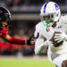 LUBBOCK, TEXAS - AUGUST 31: J.J. Henry #4 of the Abilene Christian Wildcats runs with the ball against A.J. McCarty #1 of the Texas Tech Red Raiders during the second half of the game at Jones AT&T Stadium on August 31, 2024 in Lubbock, Texas.  (Photo by John E. Moore III/Getty Images)