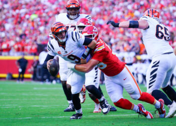 Sep 15, 2024; Kansas City, Missouri, USA; Cincinnati Bengals quarterback Joe Burrow (9) is sacked by Kansas City Chiefs defensive end George Karlaftis (56) during the first half at GEHA Field at Arrowhead Stadium. Mandatory Credit: Denny Medley-Imagn Images