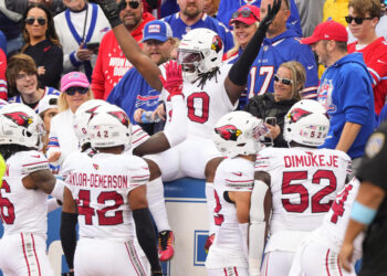 DeeJay Dallas celebrates the NFL's first return touchdown under new kickoff rules. (Gregory Fisher-Imagn Images)