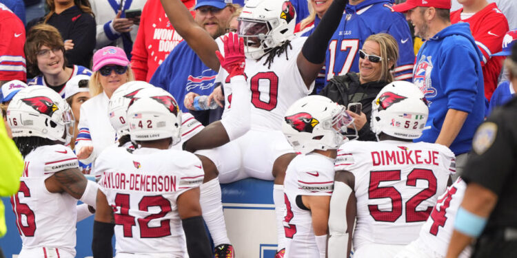 DeeJay Dallas celebrates the NFL's first return touchdown under new kickoff rules. (Gregory Fisher-Imagn Images)