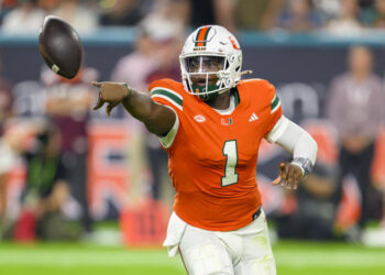 MIAMI GARDENS, FL - SEPTEMBER 27: Miami quarterback Cam Ward (1) does a shovel pass during the college football game between the Virginia Tech Hokies and the University of Miami Hurricanes on September 27, 2024 at the Hard Rock Stadium in Miami Gardens, FL. (Photo by Doug Murray/Icon Sportswire via Getty Images)