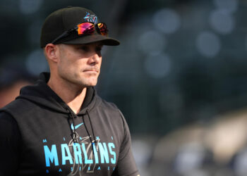 Miami Marlins manager Skip Schumaker (45) warms up before a baseball game Wednesday, Aug. 28, 2024, in Denver. (AP Photo/David Zalubowski)