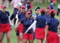 Megan Khang and Nelly Korda of Team United States react with teammates Rose Zhang and Andrea Lee after winning their match during the Friday Fourball matches against Team Europe during the first round of the Solheim Cup 2024 at Robert Trent Jones Golf Club on September 13, 2024 in Gainesville, Virginia.