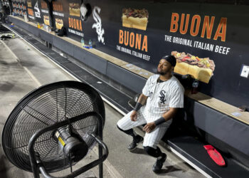 Chicago White Sox's Corey Julks sits in the end of the bench after the team's 5-3 loss to the New York Mets Saturday, Aug. 31, 2024, that saw the White Sox tie the franchise season record of 106 losses in Chicago. (AP Photo/Charles Rex Arbogast)