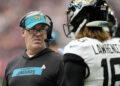 Jacksonville Jaguars head coach Doug Pederson talks with quarterback Trevor Lawrence (16) during the first half of an NFL football game against the Houston Texans, Sunday, Sept. 29, 2024, in Houston. (AP Photo/Eric Gay)