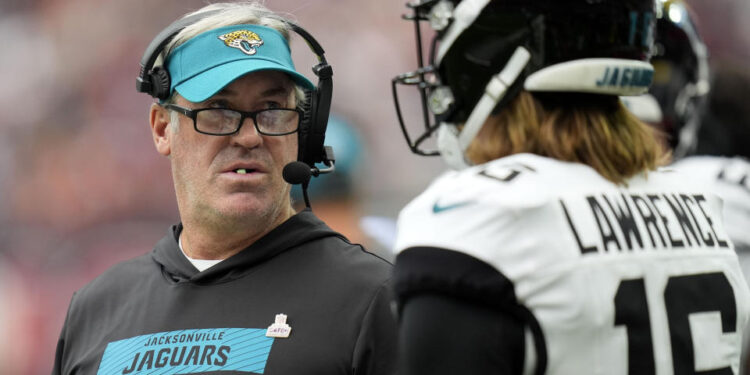 Jacksonville Jaguars head coach Doug Pederson talks with quarterback Trevor Lawrence (16) during the first half of an NFL football game against the Houston Texans, Sunday, Sept. 29, 2024, in Houston. (AP Photo/Eric Gay)