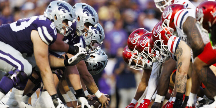 MANHATTAN, KANSAS - SEPTEMBER 13: Kansas State Wildcats offense and Arizona Wildcats defense at the line of scrimmage before an extra point attempt during a game at Bill Snyder Family Football Stadium on September 13, 2024 in Manhattan, Kansas. (Photo by Ric Tapia/Getty Images)