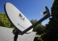 FILE - In this May 6, 2010 file photo, a DirecTV satellite dish is attached to a roof at a home in Palo Alto, Calif. The government is taking the nation's biggest satellite TV provider to court, accusing DirecTV of misleading millions of consumers about the cost of its programming. The Federal Trade Commission said Wednesday that its complaint charges DirecTV Inc. with deceptively advertising a discounted 12-month programming package. Consumers weren't clearly told that the package requires a two-year contract, the commission said. (AP Photo/Paul Sakuma, File)