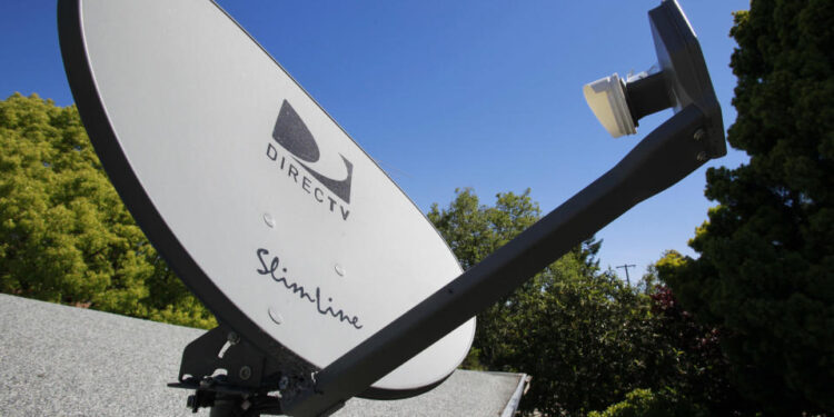 FILE - In this May 6, 2010 file photo, a DirecTV satellite dish is attached to a roof at a home in Palo Alto, Calif. The government is taking the nation's biggest satellite TV provider to court, accusing DirecTV of misleading millions of consumers about the cost of its programming. The Federal Trade Commission said Wednesday that its complaint charges DirecTV Inc. with deceptively advertising a discounted 12-month programming package. Consumers weren't clearly told that the package requires a two-year contract, the commission said. (AP Photo/Paul Sakuma, File)