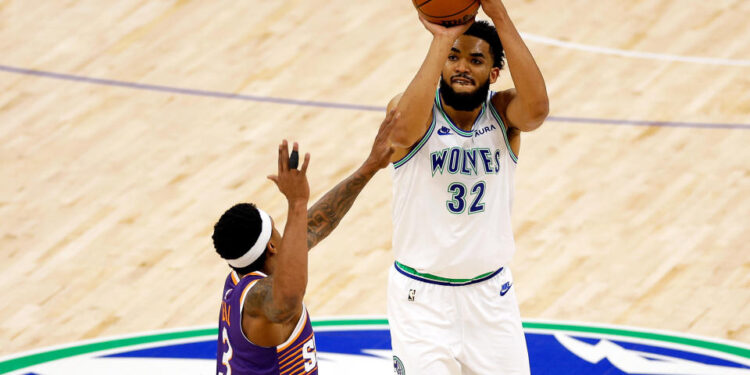 MINNEAPOLIS, MINNESOTA - APRIL 23: Karl-Anthony Towns #32 of the Minnesota Timberwolves shoots against Bradley Beal #3 of the Phoenix Suns in the first quarter of game two of the Western Conference First Round Playoffs at Target Center on April 23, 2024 in Minneapolis, Minnesota. NOTE TO USER: User expressly acknowledges and agrees that, by downloading and or using this photograph, User is consenting to the terms and conditions of the Getty Images License Agreement. (Photo by David Berding/Getty Images)