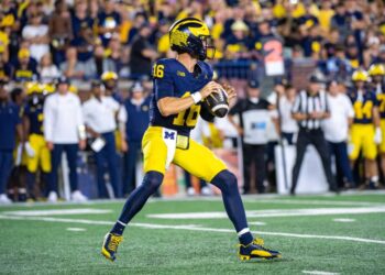 ANN ARBOR, MICHIGAN - AUGUST 31: Davis Warren #16 of the Michigan Wolverines looks to throw the ball downfield during the second half of  a college football game against the Fresno St. Bulldogs at Michigan Stadium on August 31, 2024 in Ann Arbor, Michigan. The Michigan Wolverines won the game 30-10. (Photo by Aaron J. Thornton/Getty Images)