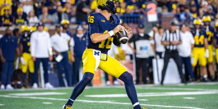 ANN ARBOR, MICHIGAN - AUGUST 31: Davis Warren #16 of the Michigan Wolverines looks to throw the ball downfield during the second half of  a college football game against the Fresno St. Bulldogs at Michigan Stadium on August 31, 2024 in Ann Arbor, Michigan. The Michigan Wolverines won the game 30-10. (Photo by Aaron J. Thornton/Getty Images)