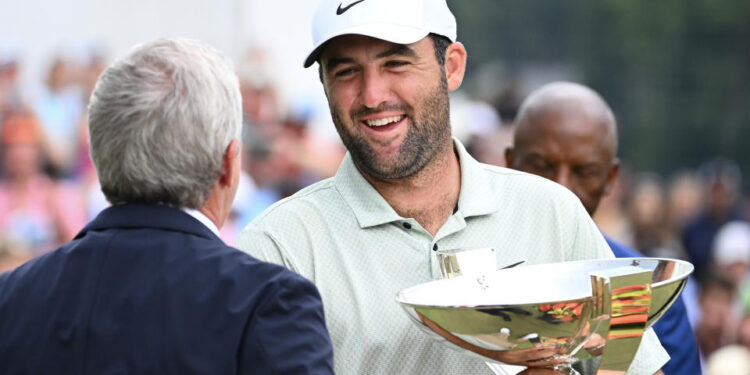 ATLANTA, GEORGIA - SEPTEMBER 01: PGA TOUR Commissioner Jay Monahan awards Scottie Scheffler of the United States the FedEx Cup after winning the TOUR Championship at East Lake Golf Club on September 01, 2024 in Atlanta, Georgia. (Photo by Tracy Wilcox/PGA TOUR via Getty Images)