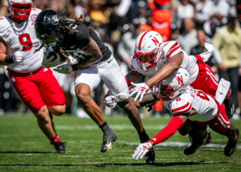 BOULDER, CO - SEPTEMBER 09: Colorado wide receiver Xavier Weaver (10) attempts to split the tackle of Nebraska Defensive back Quinton Newsome (6) and Defensive back DeShon Singleton (8) during the home opener game between the Colorado Buffaloes and the the Nebraska Cornhuskers on Saturday, September 9, 2023 at Folsom Field in Boulder, CO.  (Photo by Nick Tre. Smith/Icon Sportswire via Getty Images)