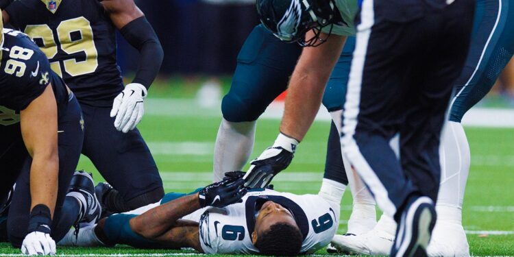 DeVonta Smith lays on turf