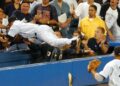 Derek Jeter dives into the stands