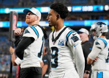 Andy Dalton and Bryce Young of the Carolina Panthers watch during the second half of their preseason game against the New York Jets at Bank of America Stadium on August 17, 2024 in Charlotte, North Carolina.